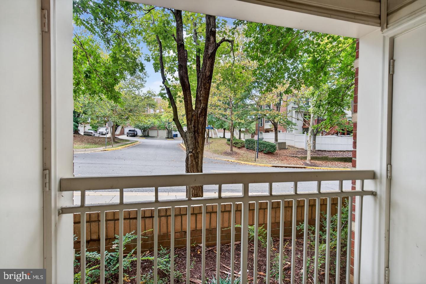 9490 Virginia Center Boulevard, Unit 127 Vienna, VA 22181 - Photo 17 of 31 a view of a porch with a floor to ceiling window and wooden fence