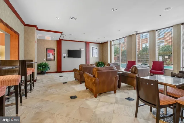 a room with pool table and windows