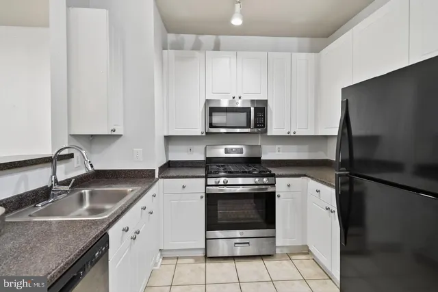 a kitchen with a sink stove and refrigerator
