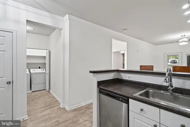 a kitchen with a sink and a refrigerator