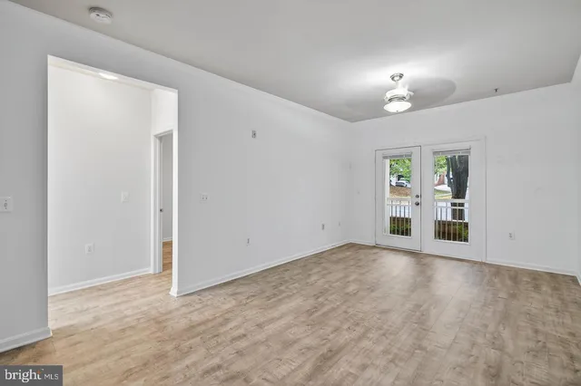 an empty room with windows and entrance