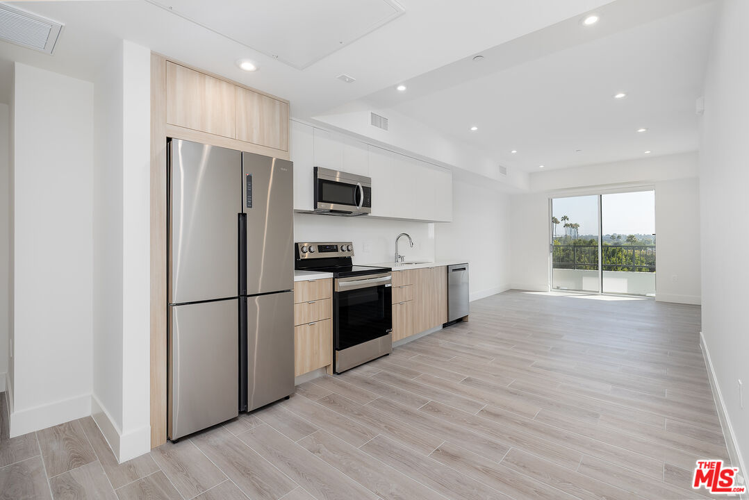2600 South Sepulveda Boulevard, Unit 410 Los Angeles, CA 90064 - Photo 22 of 33 a kitchen with stainless steel appliances a refrigerator sink and cabinets