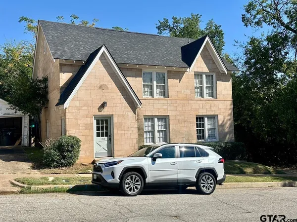a view of a car parked in front of a house