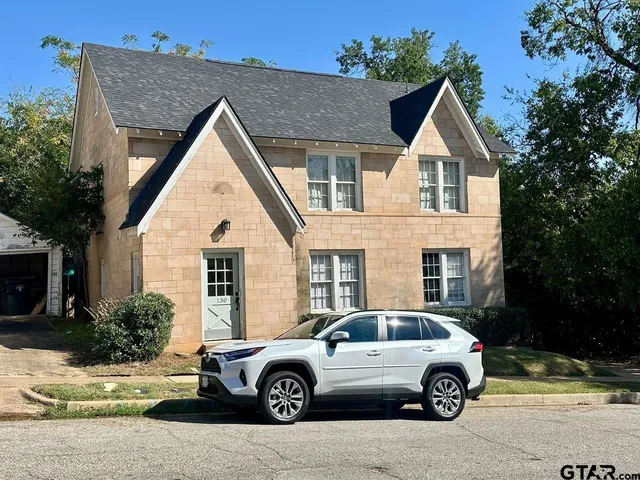 a view of a car parked in front of a house