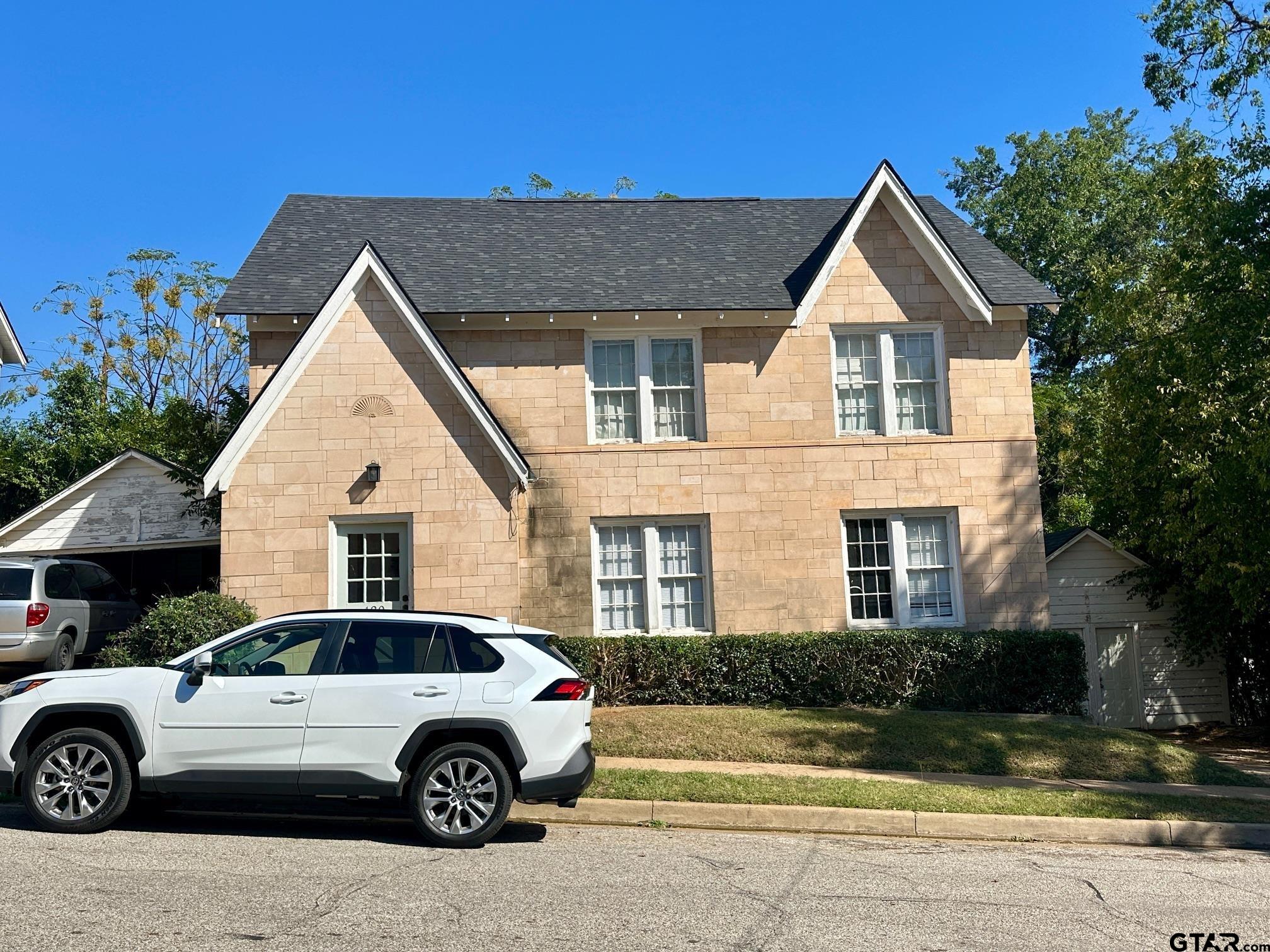 128-130 Rowland Place Tyler, TX 75701 - Photo 4 of 6 a front view of a house with a yard