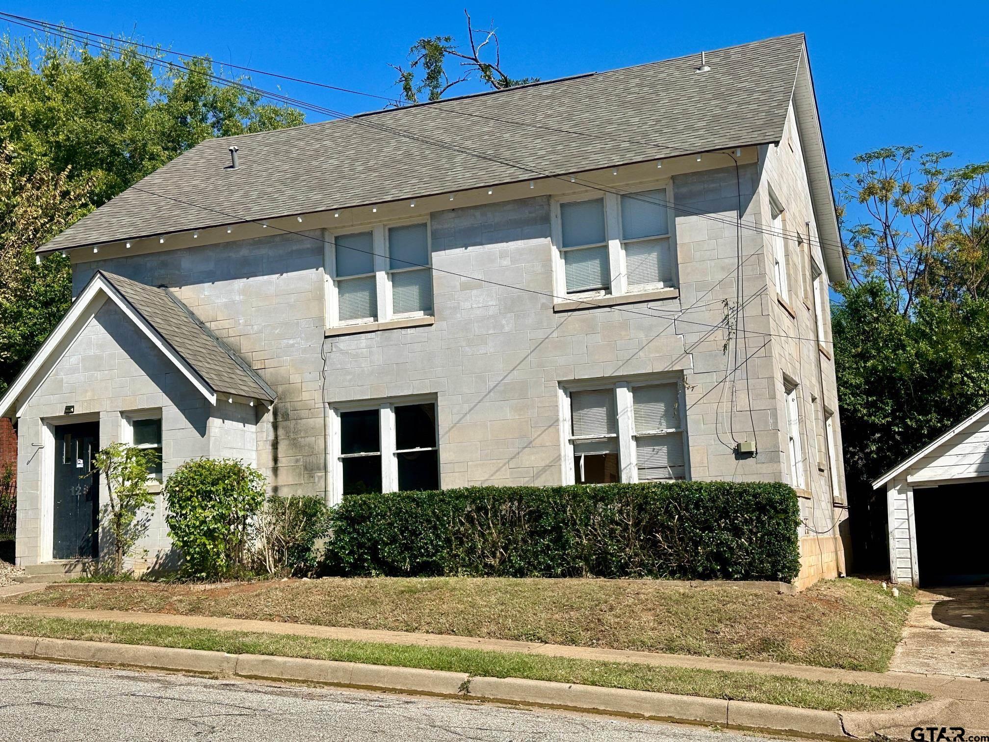 128-130 Rowland Place Tyler, TX 75701 - Photo 5 of 6 a front view of a house with a yard
