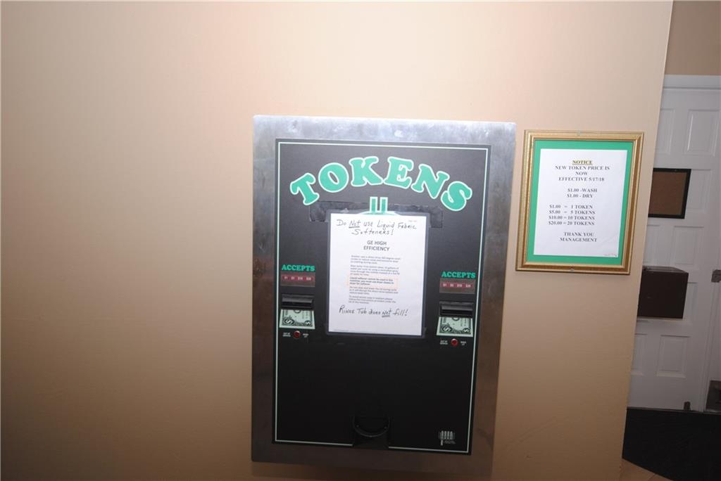 1997 Southwest Palm City Road, Unit I Stuart, FL 34994 - Photo 36 of 36 Token machine for laundry rooms located in the community building