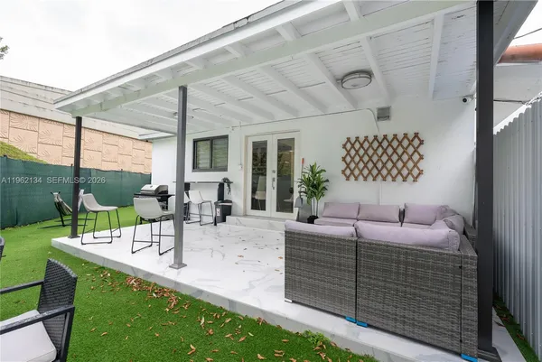 a dining room with furniture and a garden view