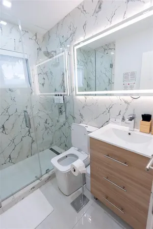 a bathroom with a sink toilet and shower