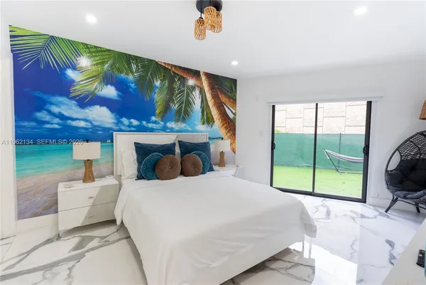 a bedroom with a bed and a large window