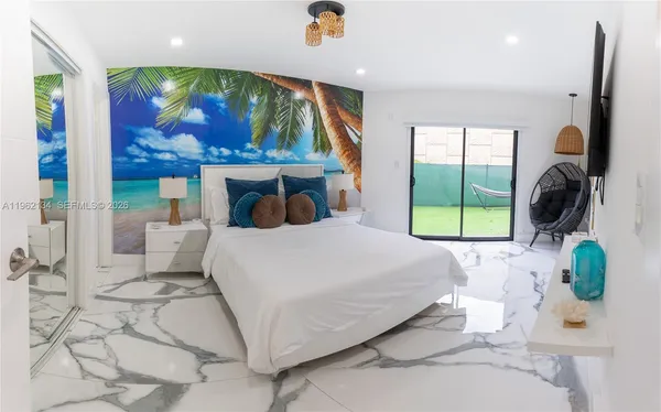 a bedroom with a large bed and a painting on the wall