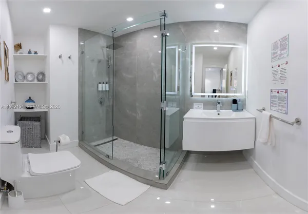 a bathroom with a double vanity sink mirror and shower