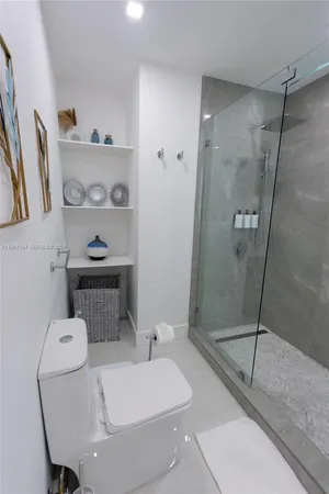 a bathroom with a toilet and a shower
