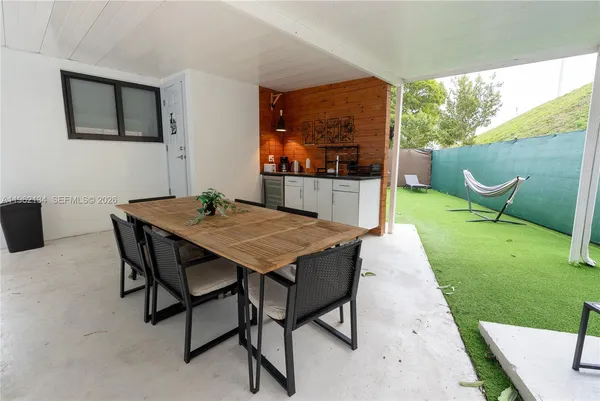a dinning table and chairs in the garden