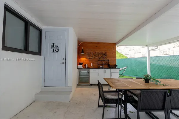 a view of an outdoor dining space with a table and chairs