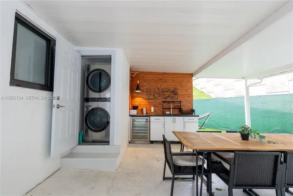 a dining room with furniture a fireplace and garden view