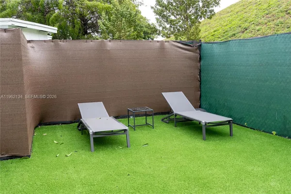 a view of a wooden bench sitting in the grass