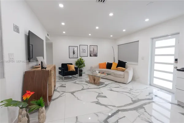 a bedroom with furniture a potted plant and a fireplace