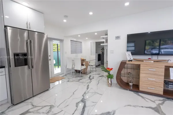 a view of a livingroom with furniture and a flat screen tv