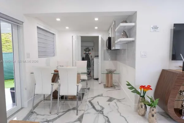 a very nice looking dining room with a large window