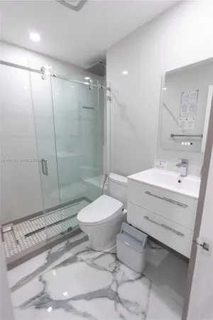 a bathroom with a sink toilet and shower