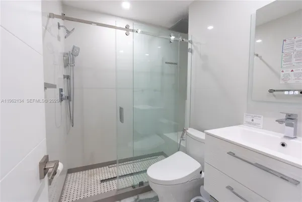 a bathroom with a sink toilet and shower