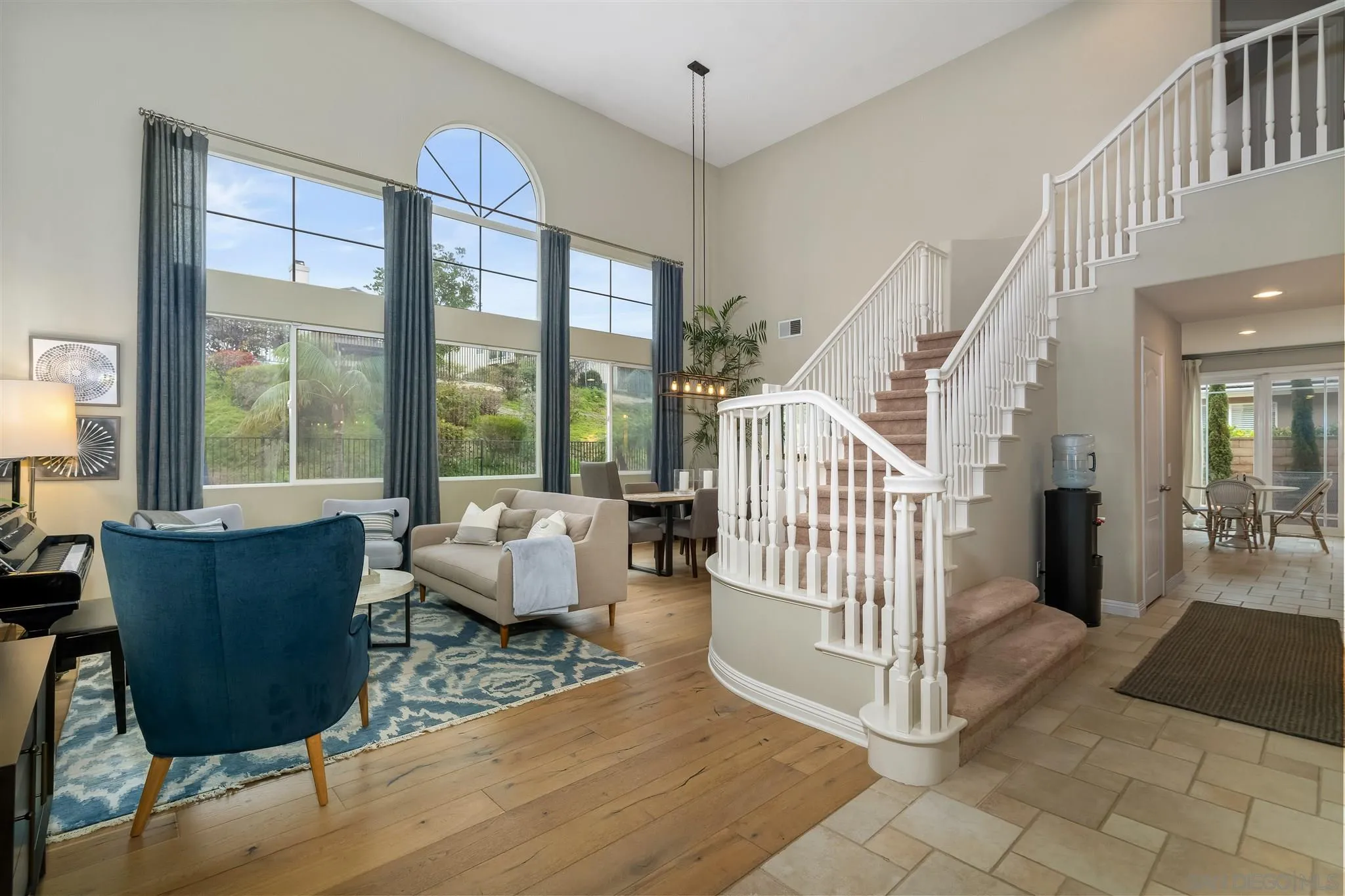 6716 Tea Tree Street Carlsbad, CA 92011 - Photo 4 of 39 a living room with furniture and large windows