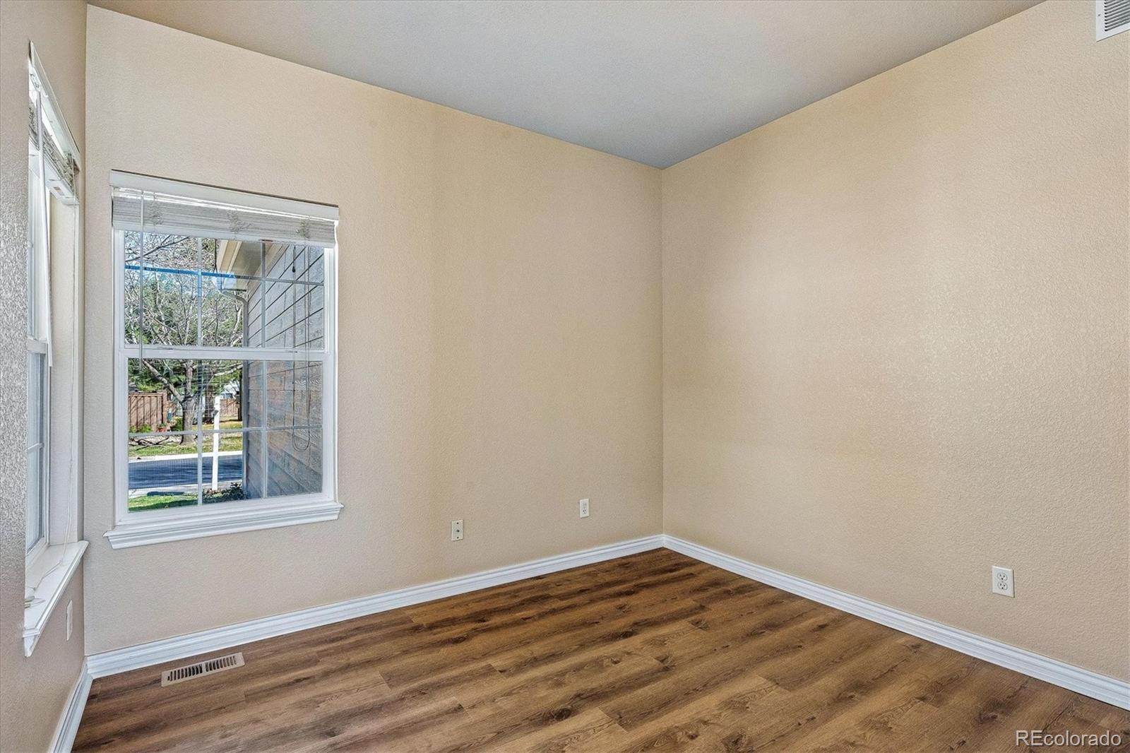 4545 South Taft Way Morrison, CO 80465 - Photo 17 of 24 a view of an empty room with wooden floor and a window