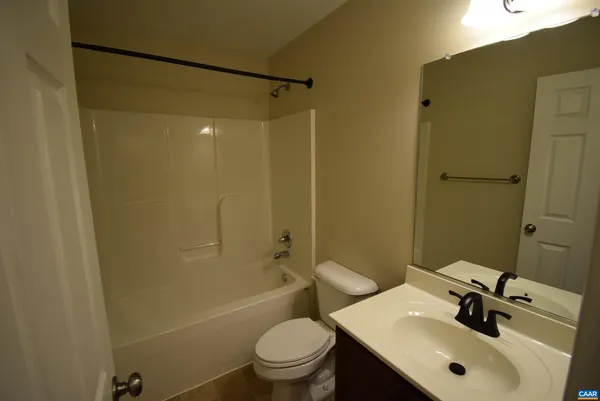 a bathroom with a sink mirror toilet and shower