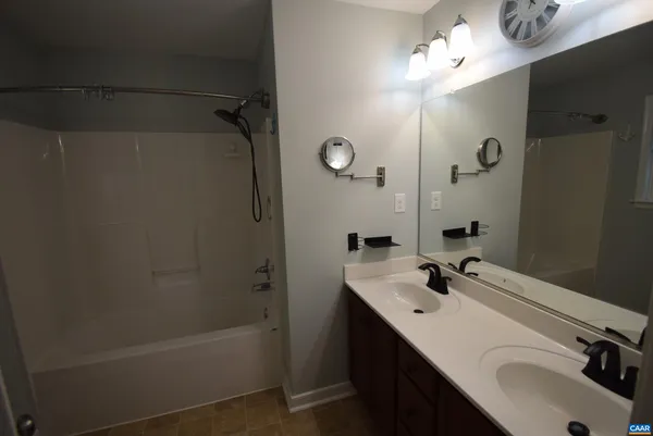 a bathroom with a sink a mirror and a bathtub