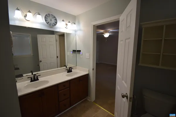 a bathroom with a double vanity sink and a mirror