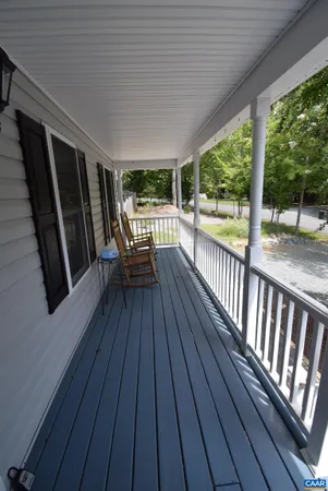 a view of deck with chairs and wooden floor