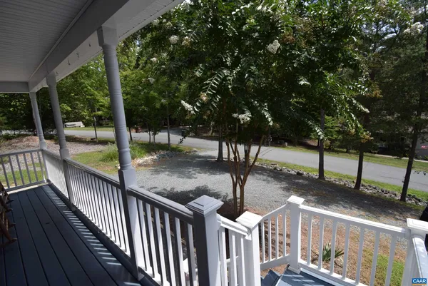 a view of a porch with wooden floor and fence