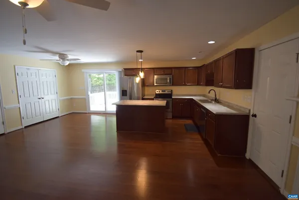 a kitchen with granite countertop a stove and a refrigerator