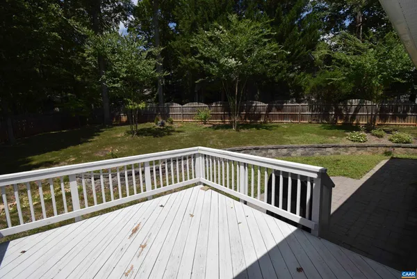 a view of a wooden deck with trees