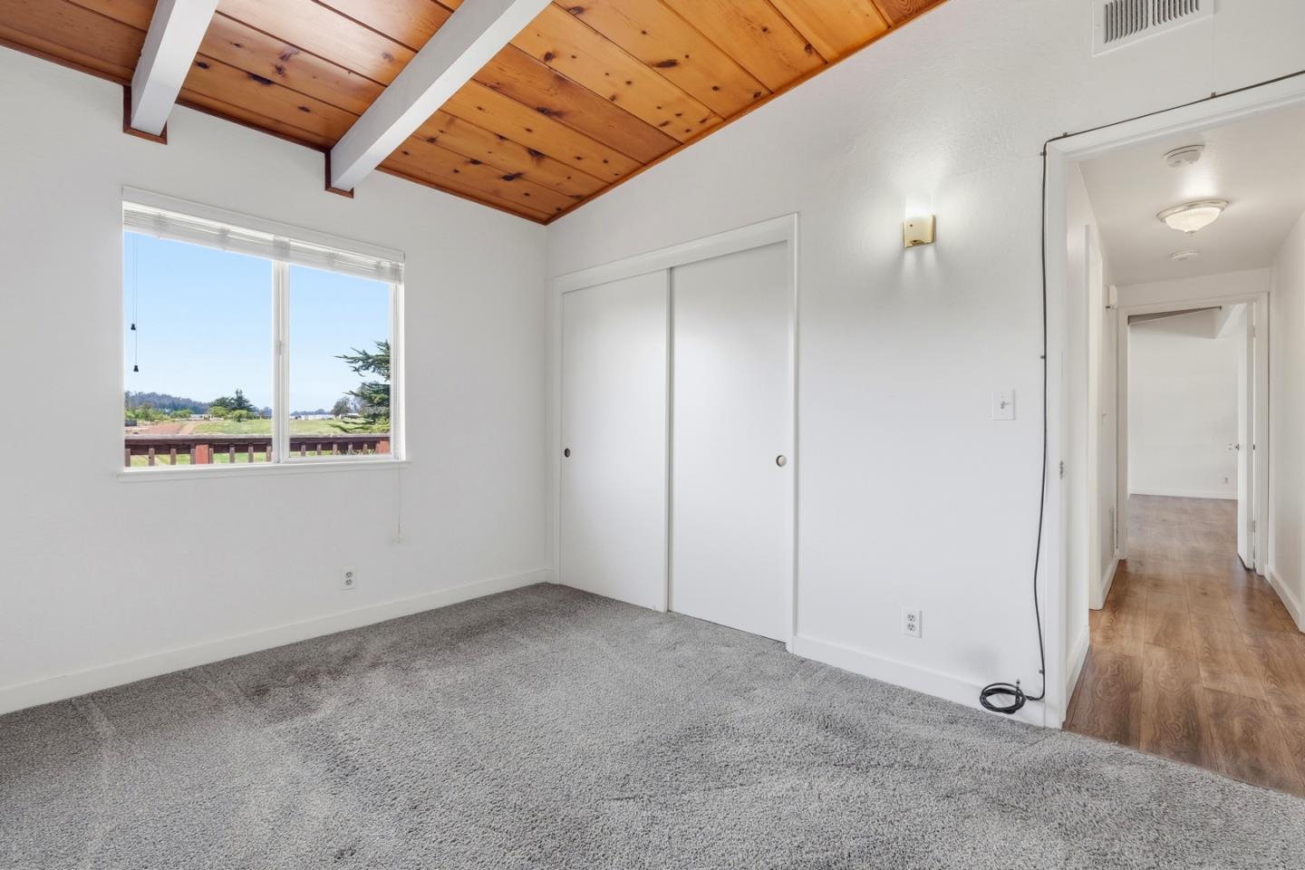 215 Manfre Road Watsonville, CA 95076 - Photo 21 of 36 an empty room with wooden floor and windows