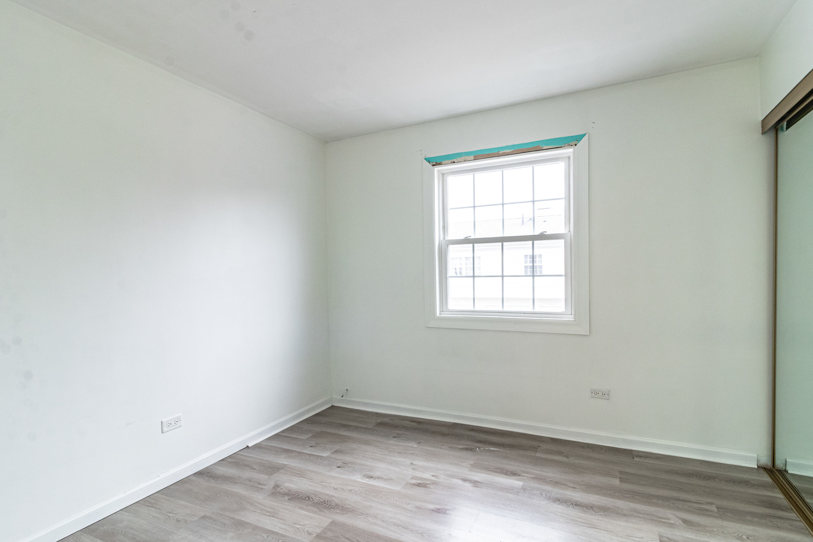 1324 Alpine Court, Unit 1324 Wheeling, IL 60090 - Photo 11 of 12 an empty room with wooden floor and windows