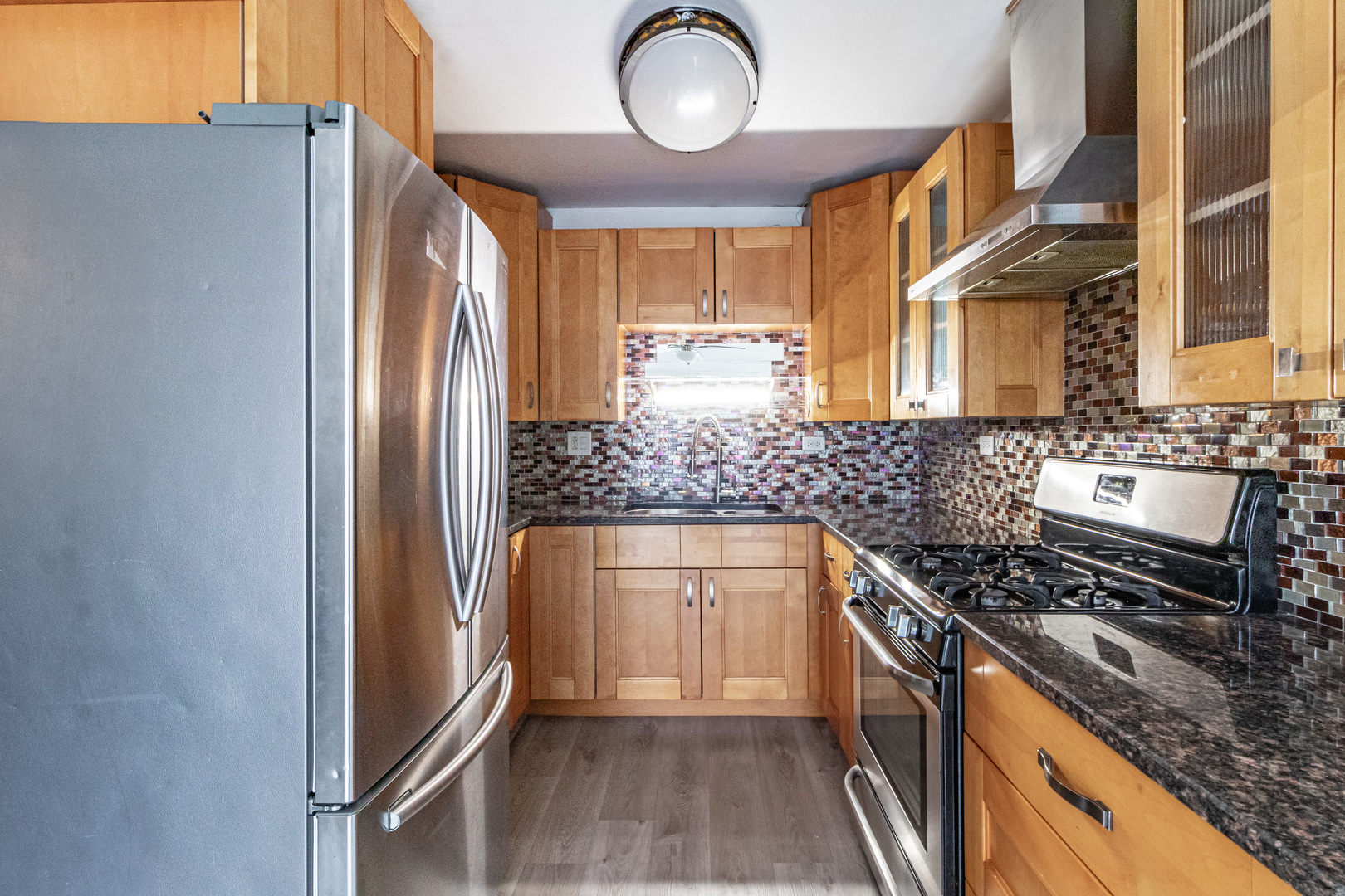 1324 Alpine Court, Unit 1324 Wheeling, IL 60090 - Photo 7 of 12 a kitchen with cabinets and appliances
