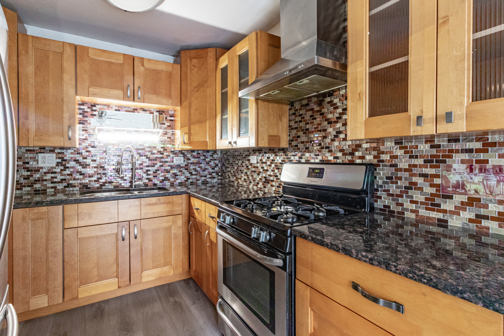 1324 Alpine Court, Unit 1324 Wheeling, IL 60090 - Photo 8 of 12 a kitchen with stainless steel appliances a stove and a sink