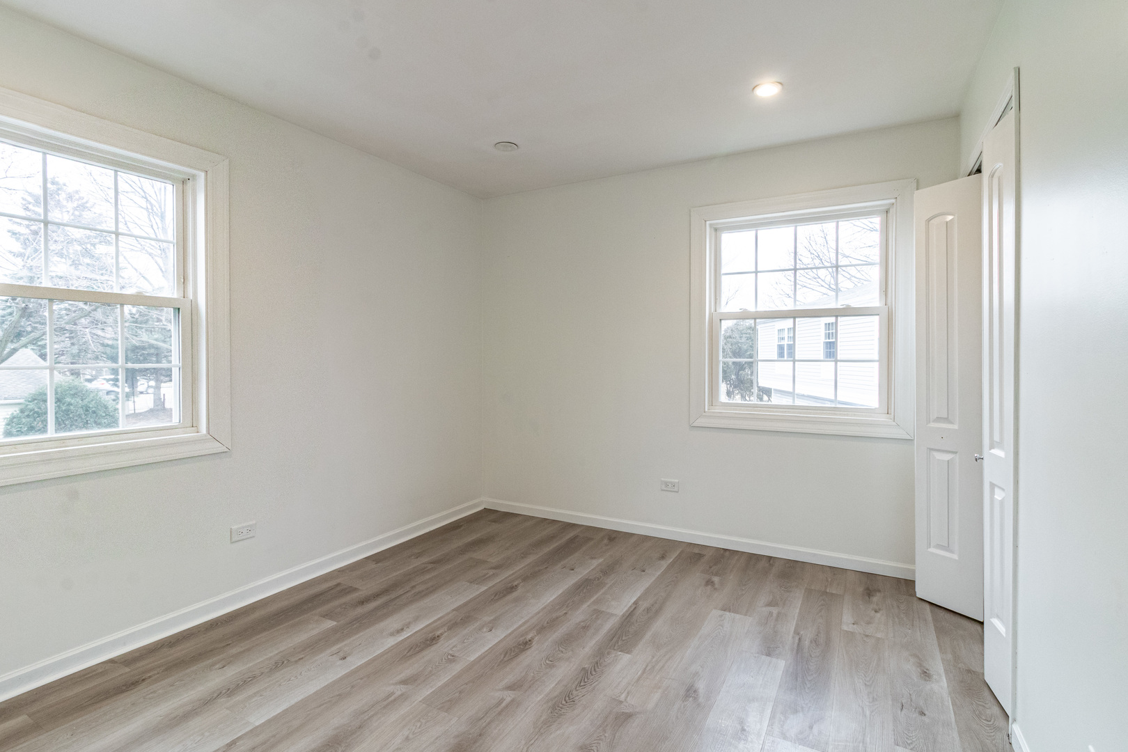 1324 Alpine Court, Unit 1324 Wheeling, IL 60090 - Photo 10 of 12 an empty room with wooden floor and windows