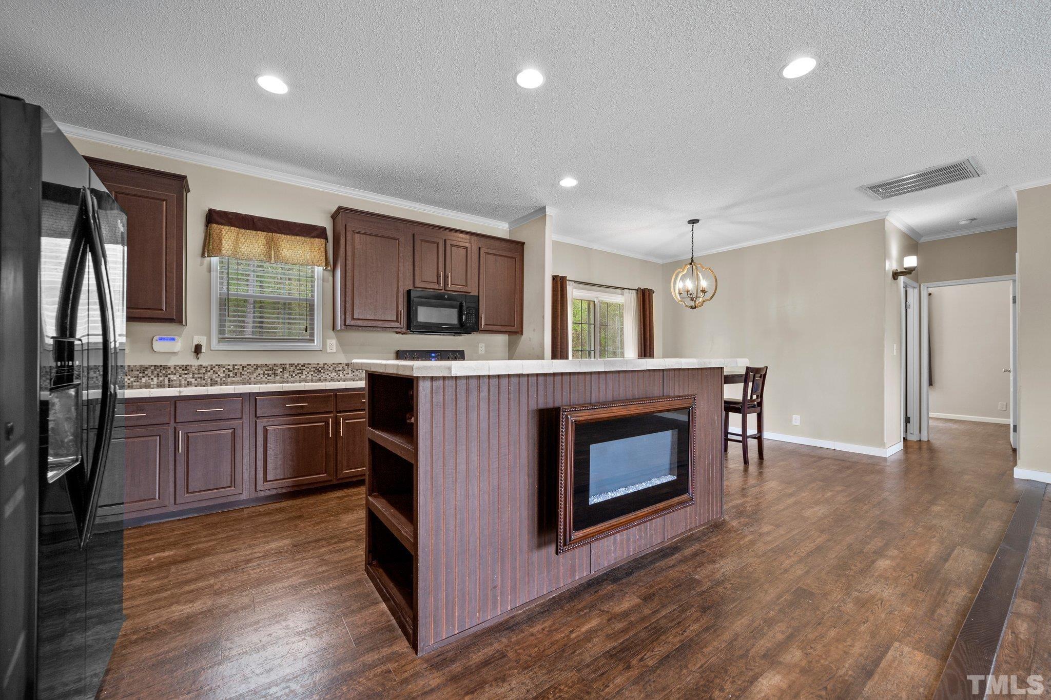 11242 Bissette Road Middlesex, NC 27557 - Photo 11 of 24 a kitchen with a stove top oven and refrigerator