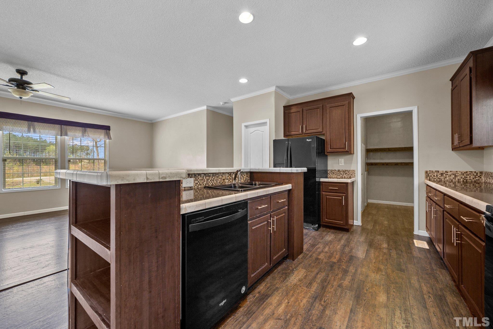 11242 Bissette Road Middlesex, NC 27557 - Photo 12 of 24 a kitchen with granite countertop a stove top oven and cabinets