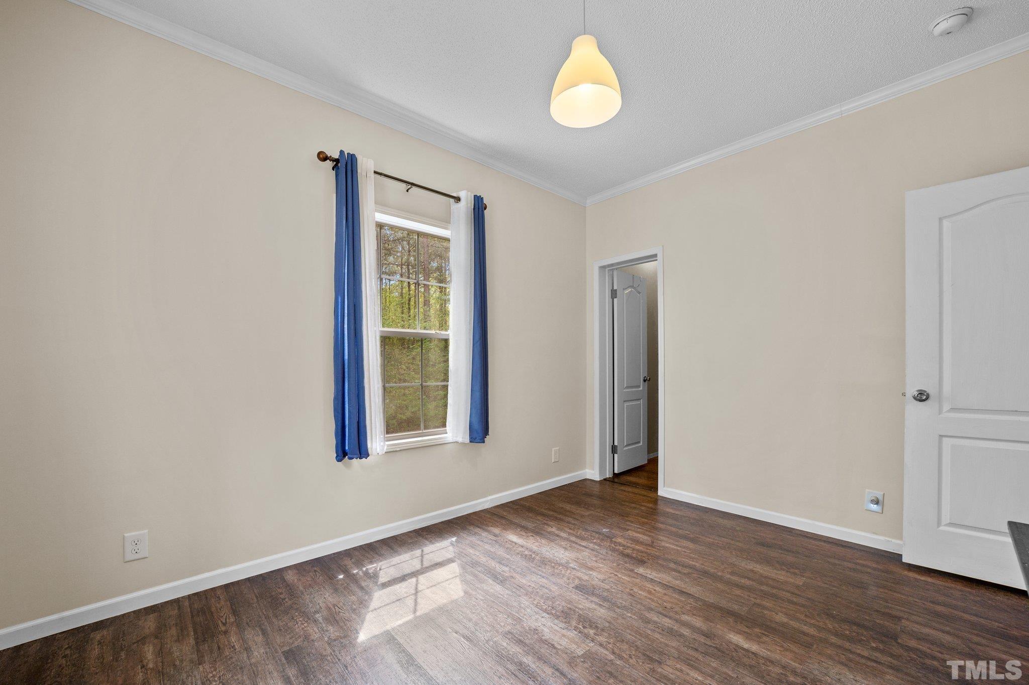 11242 Bissette Road Middlesex, NC 27557 - Photo 18 of 24 an empty room with wooden floor and windows