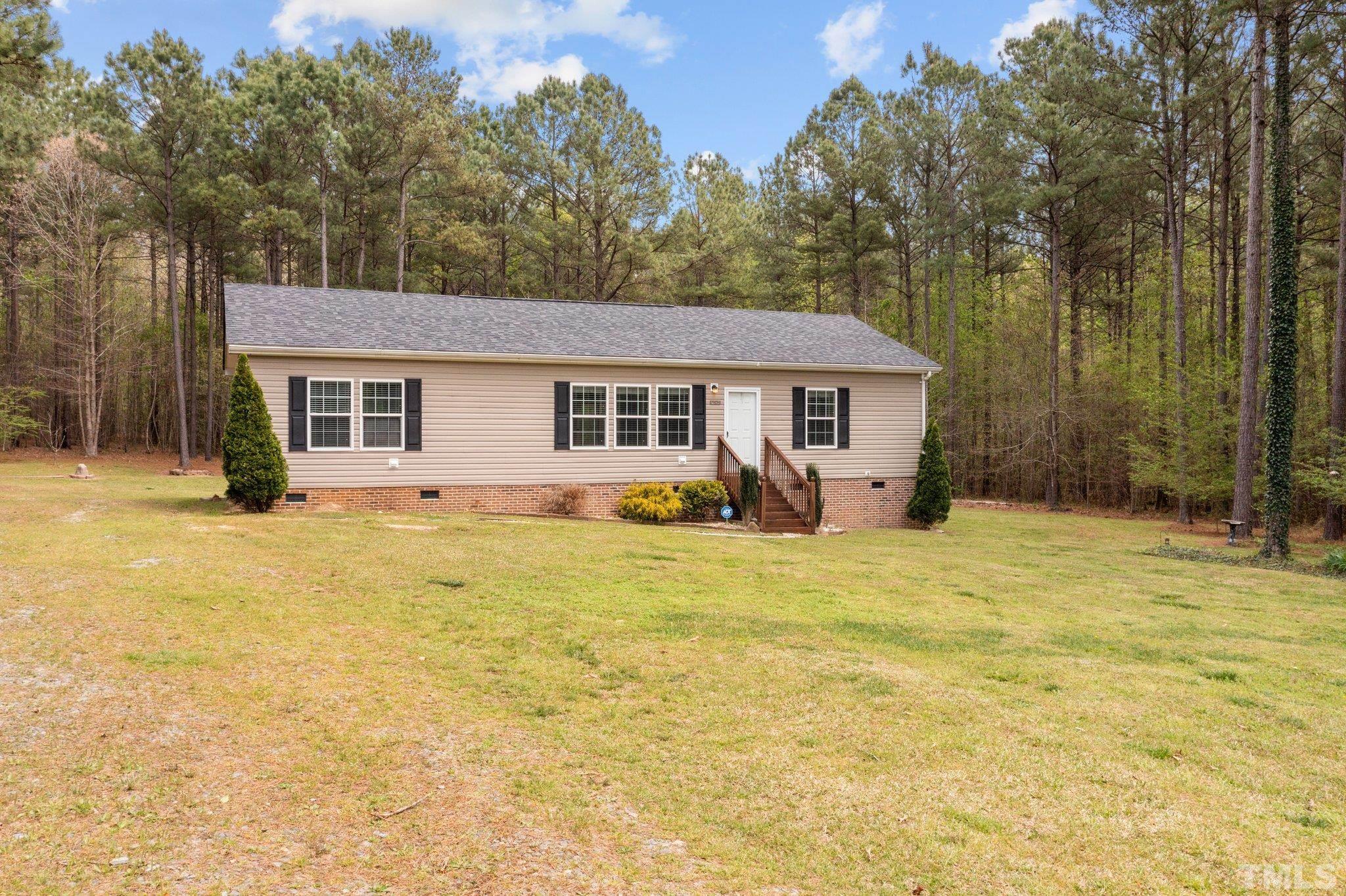 11242 Bissette Road Middlesex, NC 27557 - Photo 2 of 24 a view of a house with pool and chairs