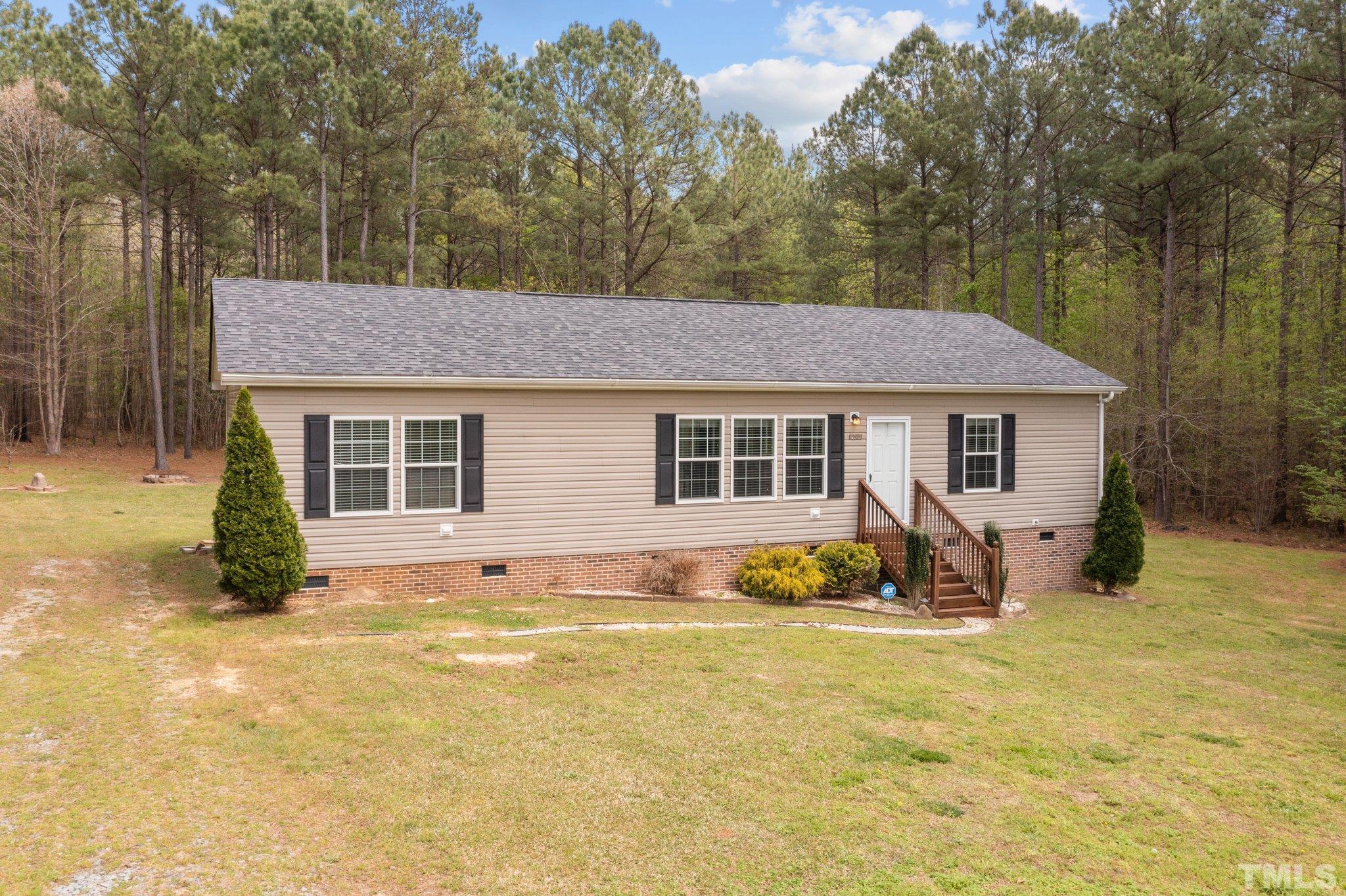 11242 Bissette Road Middlesex, NC 27557 - Photo 3 of 24 a front view of a house with yard and seating space