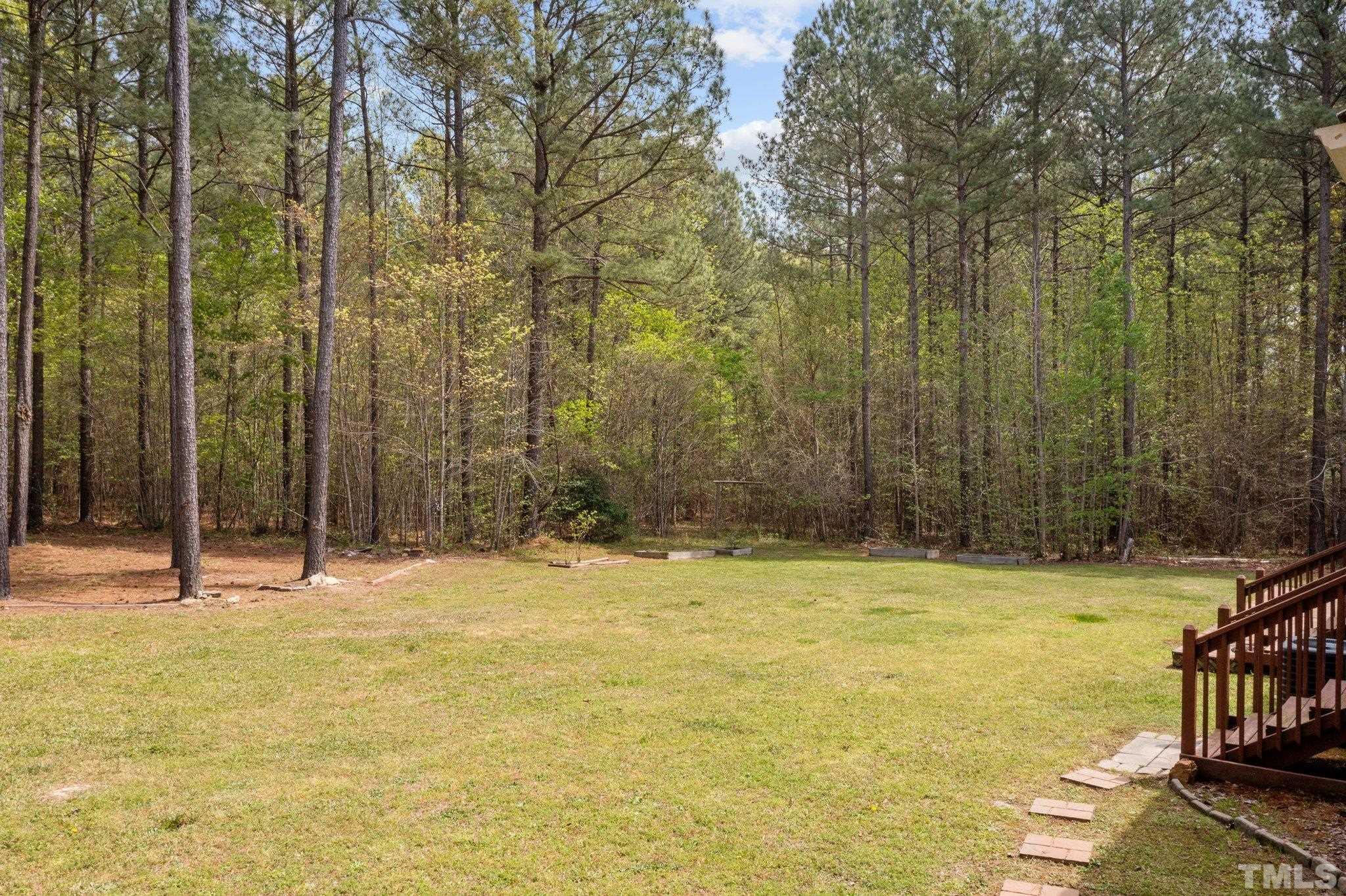 11242 Bissette Road Middlesex, NC 27557 - Photo 4 of 24 a view of swimming pool with lawn chairs and wooden fence