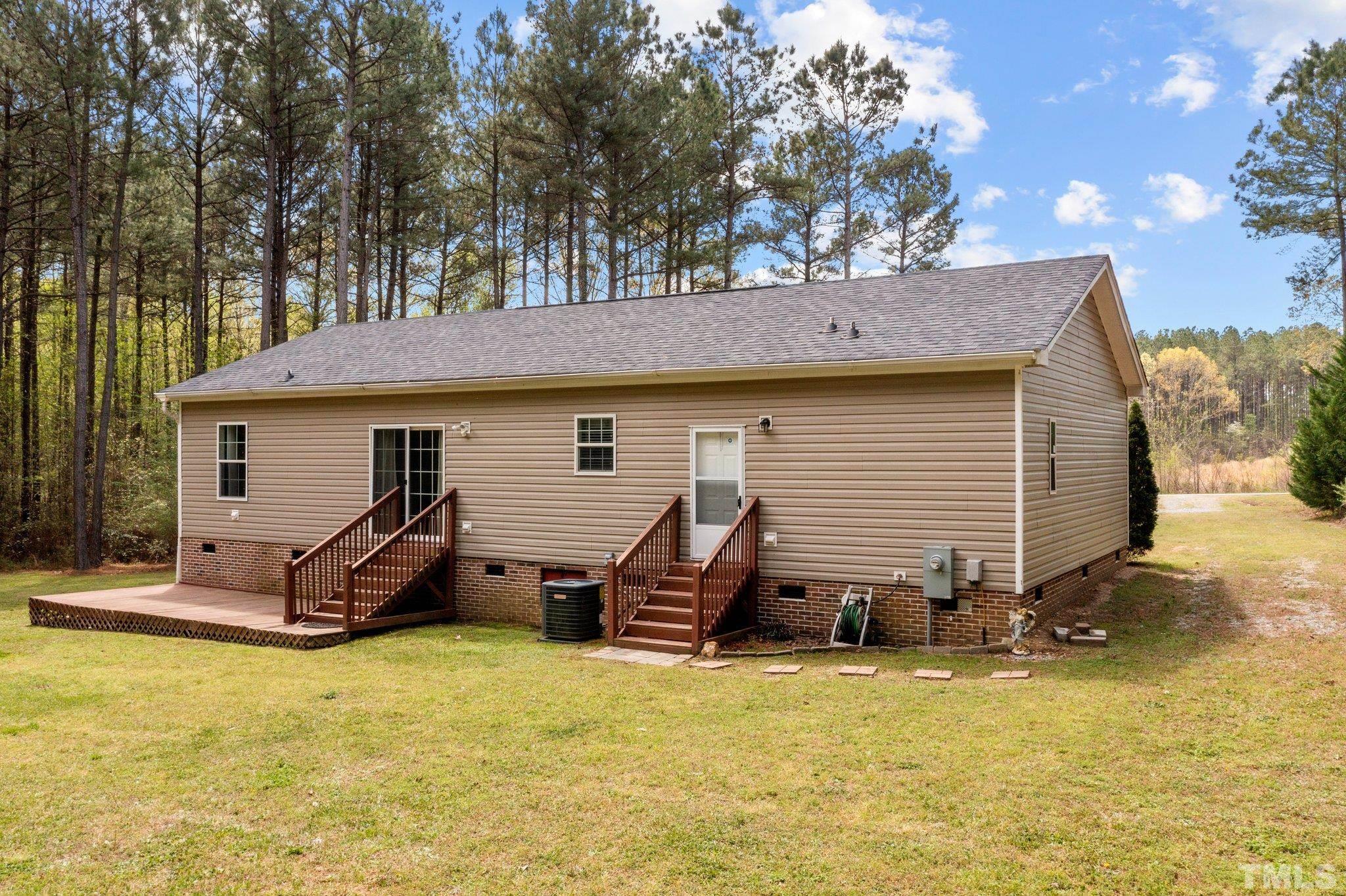 11242 Bissette Road Middlesex, NC 27557 - Photo 5 of 24 a view of a house with a yard chairs and a tree