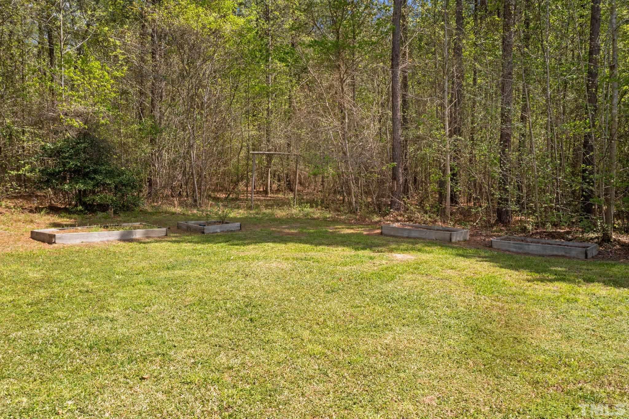 11242 Bissette Road Middlesex, NC 27557 - Photo 7 of 24 a view of a swimming pool with an outdoor space