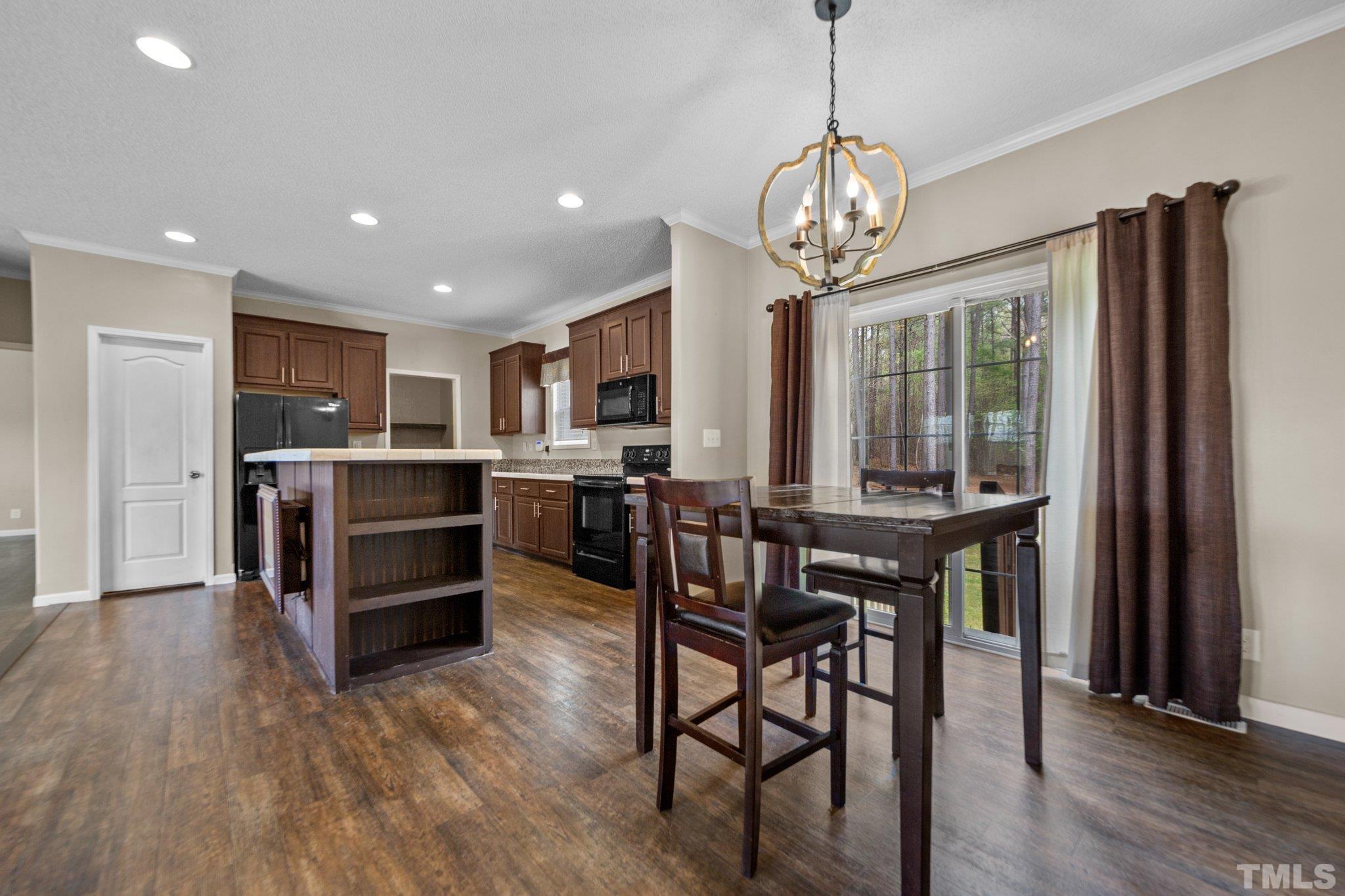 11242 Bissette Road Middlesex, NC 27557 - Photo 10 of 24 a view of a dining room with furniture window and wooden floor