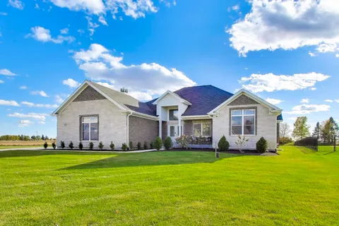 a front view of house with yard and green space